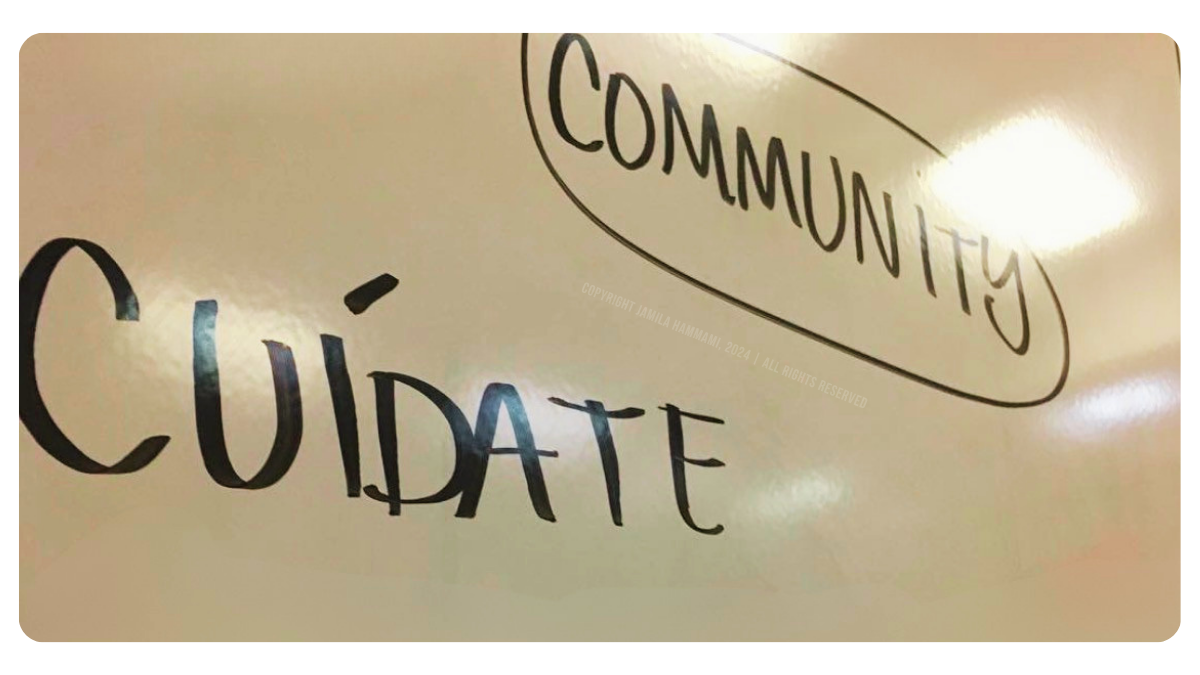Dry-erase board with the words “Community” and “Cuídate” while facilitating a migration organizing training. Malibu, California, October 2017. | Photo Credit & Copyright: Jamila Hammami, 2017. | All Rights Reserved.